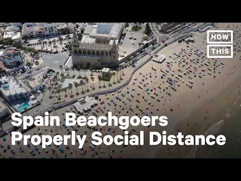 Beachgoers in Spain Practice Social Distancing Amid COVID-19 Pandemic | NowThis